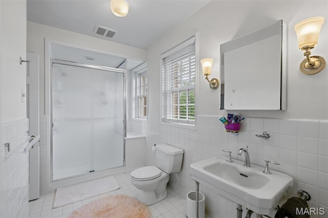 20 Ridgemoor Dr, Clayton, MO 63105 - bathroom featuring tile walls, a shower stall, a wainscoted wall, and tile patterned flooring