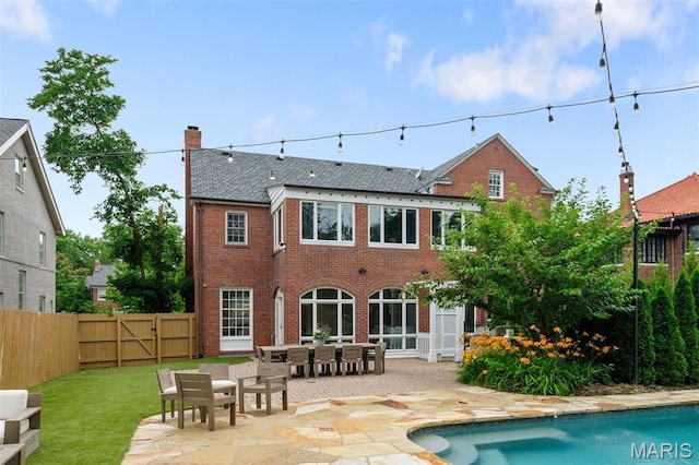 20 Ridgemoor Dr, Clayton, MO 63105 - rear view of house with a patio area, brick siding, a chimney, and outdoor dining area