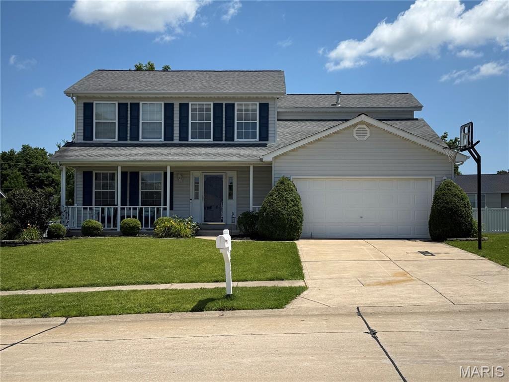 3924 Cambridge Crossing Dr, Saint Charles, MO 63304 - view of front of house featuring a garage, driveway, a front lawn, a porch, and roof with shingles