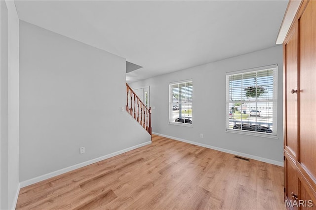3924 Cambridge Crossing Dr, Saint Charles, MO 63304 - unfurnished room featuring light wood-style floors and stairs