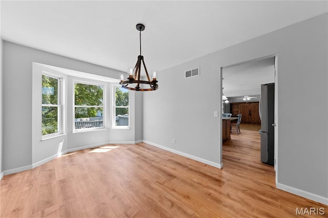 3924 Cambridge Crossing Dr, Saint Charles, MO 63304 - unfurnished dining area with a chandelier and light wood-style floors
