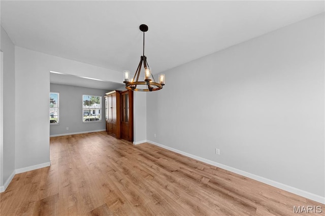 3924 Cambridge Crossing Dr, Saint Charles, MO 63304 - spare room featuring a chandelier and light wood-style flooring
