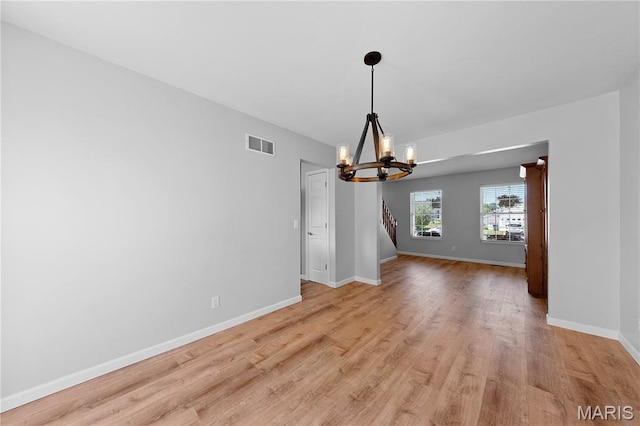 3924 Cambridge Crossing Dr, Saint Charles, MO 63304 - empty room featuring a chandelier and light wood-style flooring