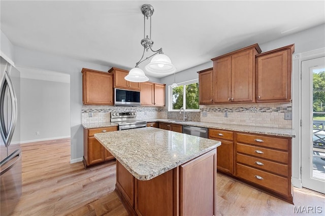 3924 Cambridge Crossing Dr, Saint Charles, MO 63304 - kitchen with appliances with stainless steel finishes, light wood-style floors, and decorative backsplash
