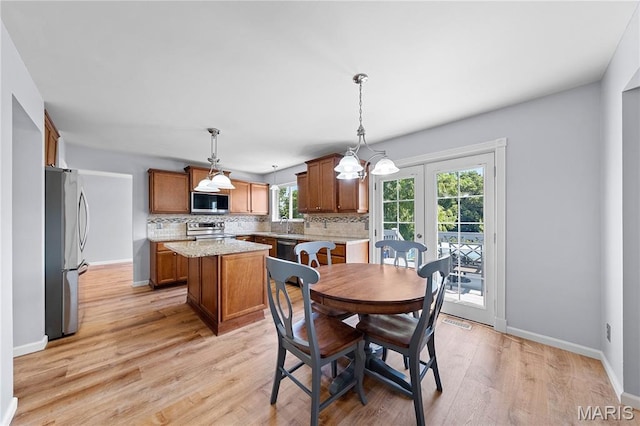 3924 Cambridge Crossing Dr, Saint Charles, MO 63304 - dining area with light wood-style floors and french doors