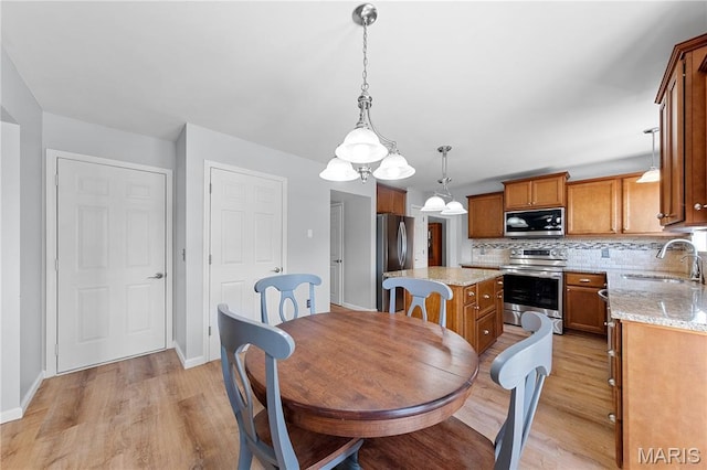 3924 Cambridge Crossing Dr, Saint Charles, MO 63304 - dining room featuring light wood finished floors and a chandelier