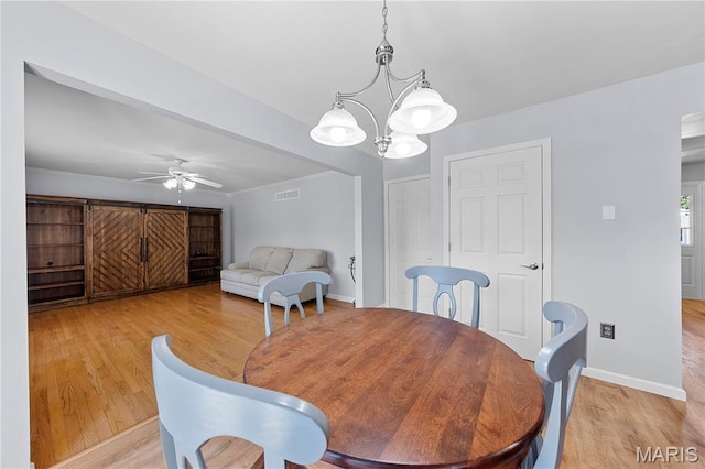 3924 Cambridge Crossing Dr, Saint Charles, MO 63304 - dining room featuring light wood-style flooring, a chandelier, and ceiling fan