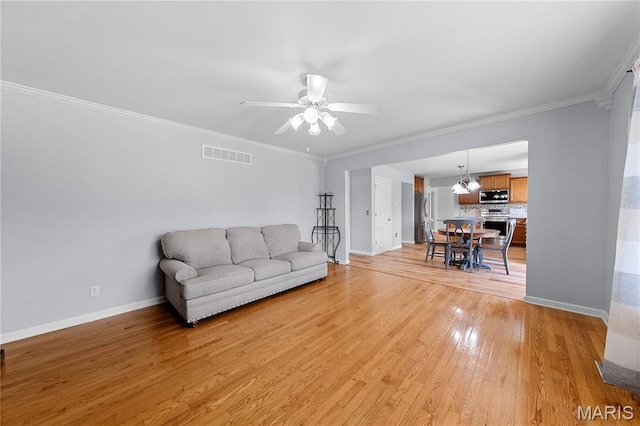 3924 Cambridge Crossing Dr, Saint Charles, MO 63304 - living room with light wood-style flooring, a ceiling fan, and ornamental molding