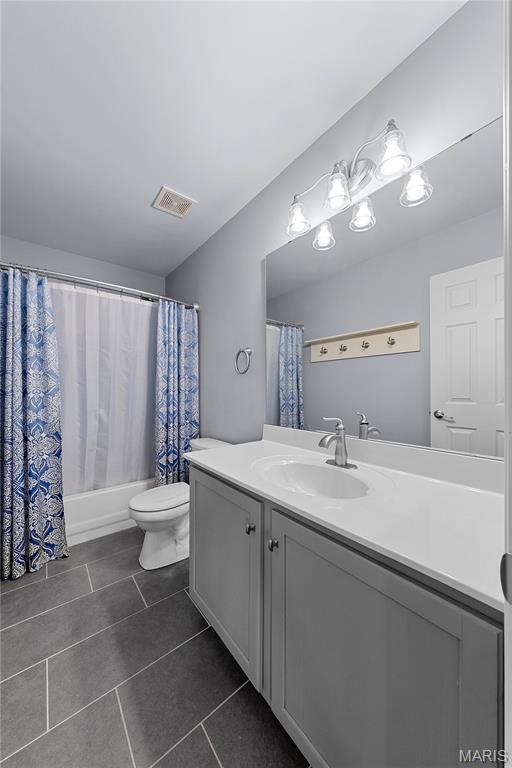 3924 Cambridge Crossing Dr, Saint Charles, MO 63304 - bathroom featuring vanity, tile patterned floors, and shower / bath combination with curtain