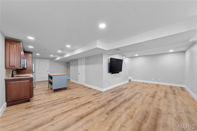 3924 Cambridge Crossing Dr, Saint Charles, MO 63304 - kitchen with appliances with stainless steel finishes, open floor plan, light wood-style floors, a kitchen island, and recessed lighting