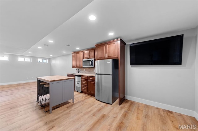 3924 Cambridge Crossing Dr, Saint Charles, MO 63304 - kitchen featuring stainless steel appliances, recessed lighting, light wood-style flooring, decorative backsplash, and butcher block counters