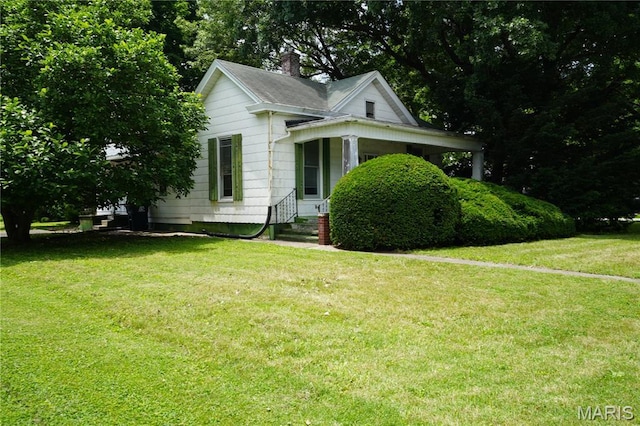 114 W 2nd St S, Mount Olive, IL 62069 - bungalow-style house with a front yard and a chimney