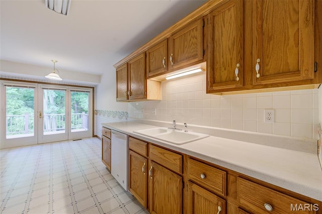 3004 Oakmont Ct Unit 15C, Saint Charles, MO 63301 - kitchen with brown cabinetry, dishwasher, light countertops, and light flooring