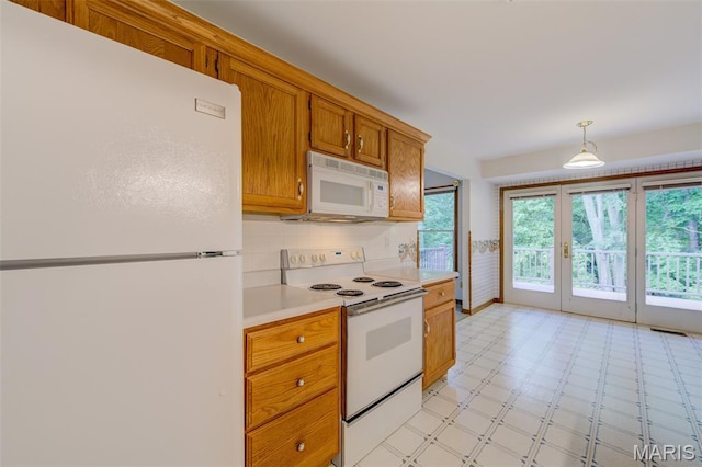 3004 Oakmont Ct Unit 15C, Saint Charles, MO 63301 - kitchen with white appliances, light flooring, light countertops, brown cabinetry, and decorative backsplash