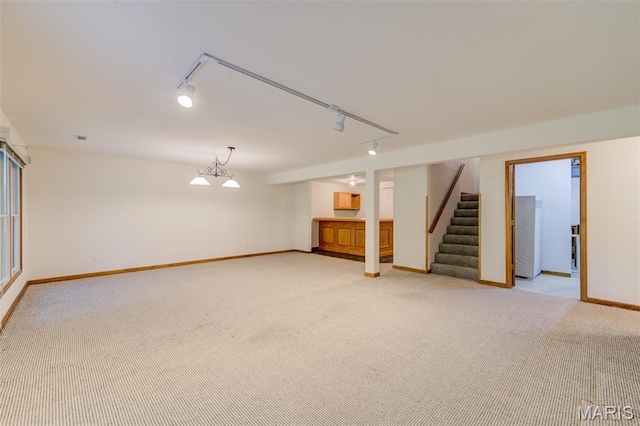 3004 Oakmont Ct Unit 15C, Saint Charles, MO 63301 - finished basement featuring rail lighting, light carpet, and stairway