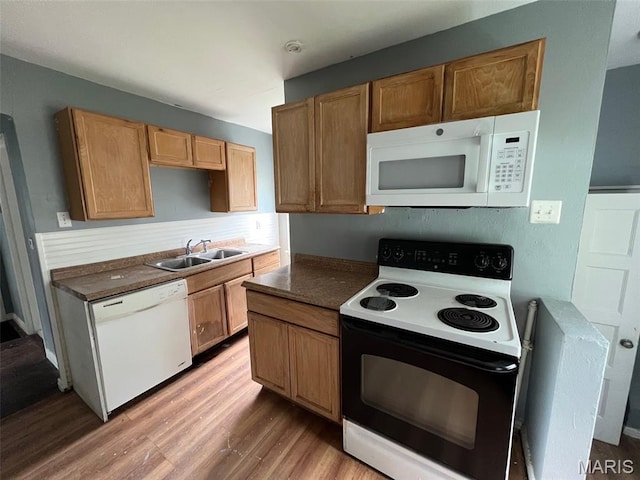 853 Nassau Dr, Saint Louis, MO 63147 - kitchen featuring white appliances, light wood finished floors, and dark countertops