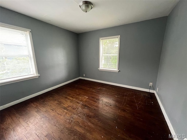 853 Nassau Dr, Saint Louis, MO 63147 - empty room featuring dark wood finished floors and baseboards