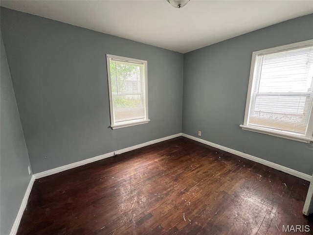 853 Nassau Dr, Saint Louis, MO 63147 - empty room with dark wood-style floors and baseboards