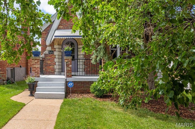 5660 Oleatha Ave, Saint Louis, MO 63139 - view of front of home featuring a front lawn and brick siding