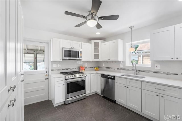 5660 Oleatha Ave, Saint Louis, MO 63139 - kitchen with stainless steel appliances, white cabinetry, tasteful backsplash, light countertops, and recessed lighting