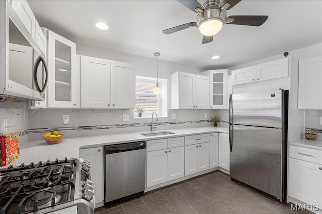 5660 Oleatha Ave, Saint Louis, MO 63139 - kitchen with stainless steel appliances, backsplash, white cabinetry, light countertops, and recessed lighting