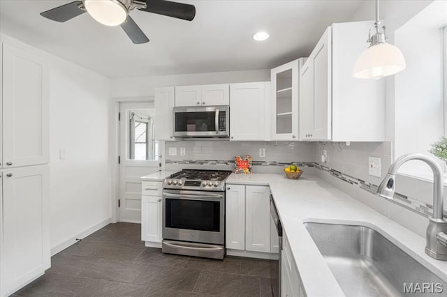 5660 Oleatha Ave, Saint Louis, MO 63139 - kitchen featuring appliances with stainless steel finishes, decorative backsplash, white cabinetry, and recessed lighting