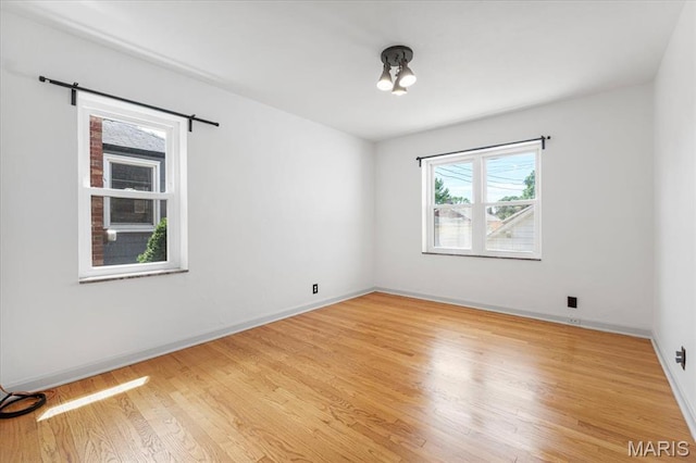 5660 Oleatha Ave, Saint Louis, MO 63139 - empty room featuring light wood-style floors and baseboards