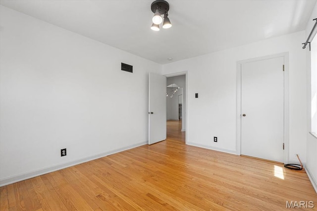 5660 Oleatha Ave, Saint Louis, MO 63139 - unfurnished bedroom featuring light wood-type flooring and baseboards