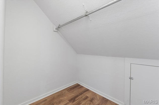 5660 Oleatha Ave, Saint Louis, MO 63139 - spacious closet with vaulted ceiling and dark wood-style flooring