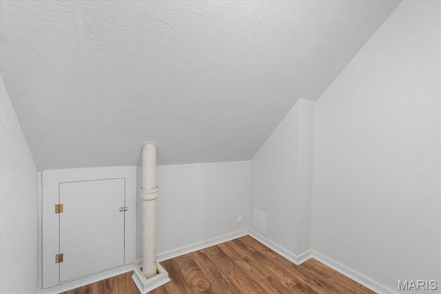 5660 Oleatha Ave, Saint Louis, MO 63139 - bonus room featuring wood finished floors, a textured ceiling, and lofted ceiling