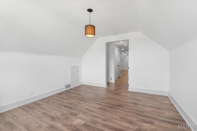 5660 Oleatha Ave, Saint Louis, MO 63139 - additional living space featuring lofted ceiling and wood finished floors