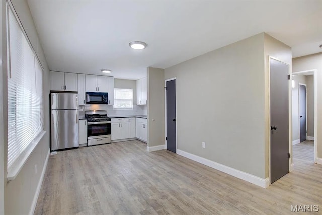 675 Pimlico Dr, Florissant, MO 63033 - kitchen featuring appliances with stainless steel finishes, light wood finished floors, and white cabinets
