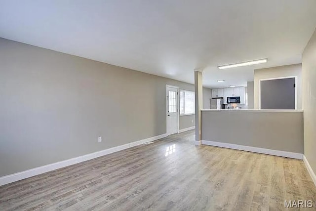 675 Pimlico Dr, Florissant, MO 63033 - unfurnished living room featuring light wood finished floors