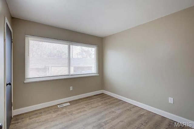 675 Pimlico Dr, Florissant, MO 63033 - spare room with wood finished floors and baseboards