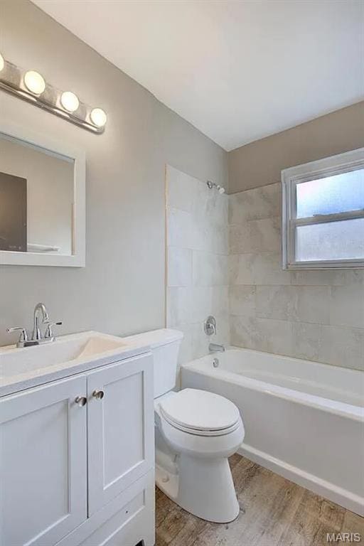 675 Pimlico Dr, Florissant, MO 63033 - bathroom with wood finished floors, vanity, and shower / bathtub combination