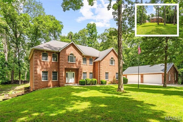 10 Algonquin Dr, Millstadt, IL 62260 - colonial-style house featuring brick siding, a garage, a front lawn, and an outbuilding