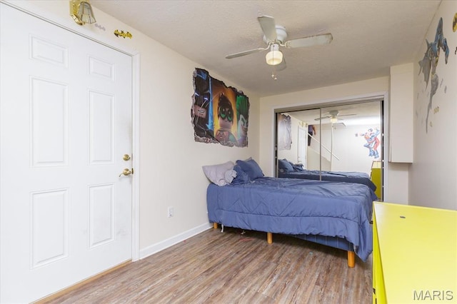 23 Trailside Ct Unit 2, Saint Peters, MO 63303 - bedroom with light wood-style flooring, a textured ceiling, a closet, and a ceiling fan