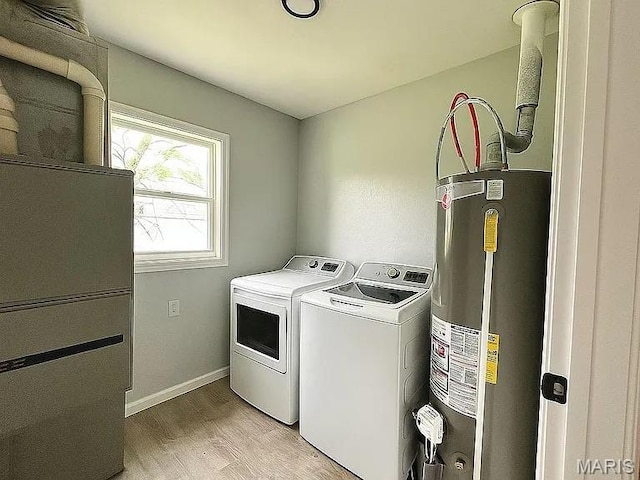 1412 N Olive St, Mexico, MO 65265 - laundry room featuring gas water heater, washer and clothes dryer, and light wood-style floors