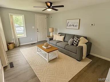 1412 N Olive St, Mexico, MO 65265 - living room featuring ceiling fan and wood finished floors