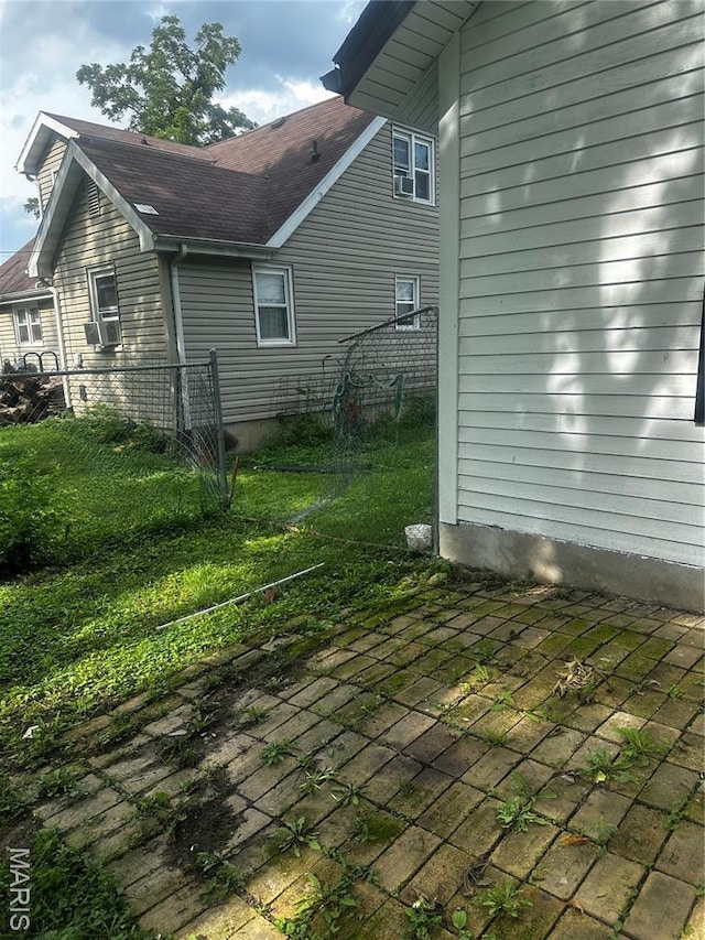 1412 N Olive St, Mexico, MO 65265 - rear view of house featuring a shingled roof, a patio, and cooling unit