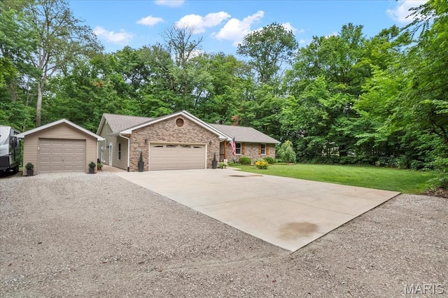 13345 Iberg Rd, Highland, IL 62249 - ranch-style home with a front yard, gravel driveway, an outbuilding, stone siding, and view of scattered trees