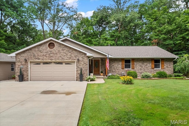 13345 Iberg Rd, Highland, IL 62249 - single story home featuring concrete driveway, a garage, a front lawn, and brick siding