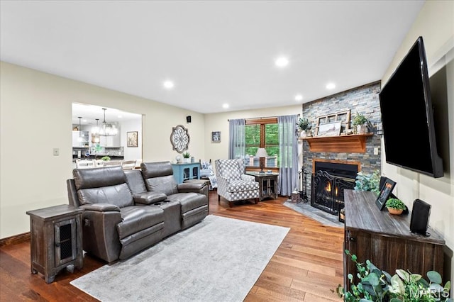 13345 Iberg Rd, Highland, IL 62249 - living room with a fireplace, wood finished floors, a chandelier, and recessed lighting