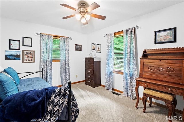 13345 Iberg Rd, Highland, IL 62249 - bedroom with multiple windows, light colored carpet, and ceiling fan