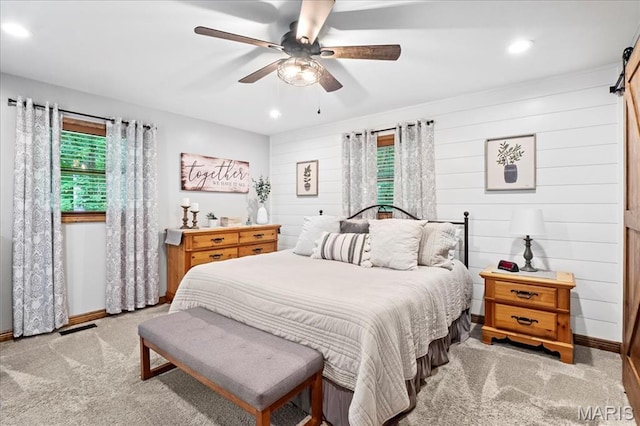 13345 Iberg Rd, Highland, IL 62249 - bedroom with carpet, recessed lighting, ceiling fan, a barn door, and wooden walls