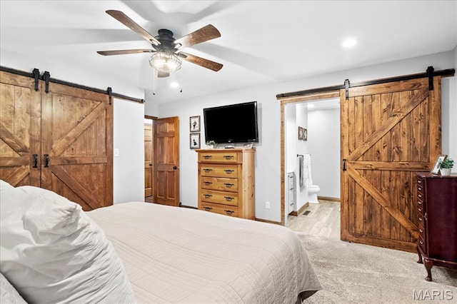 13345 Iberg Rd, Highland, IL 62249 - bedroom with a barn door, recessed lighting, ensuite bathroom, a ceiling fan, and wood finished floors