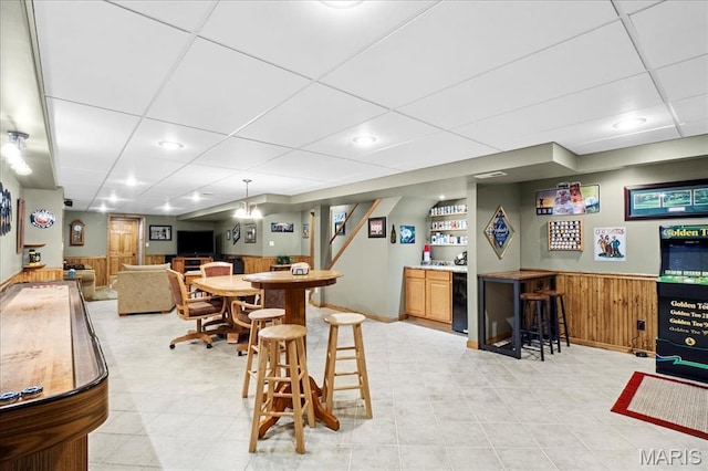 13345 Iberg Rd, Highland, IL 62249 - indoor dry bar featuring wainscoting, wood walls, and a paneled ceiling