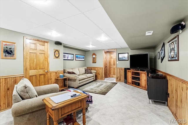 13345 Iberg Rd, Highland, IL 62249 - living area featuring wainscoting, wooden walls, light tile patterned flooring, and a drop ceiling