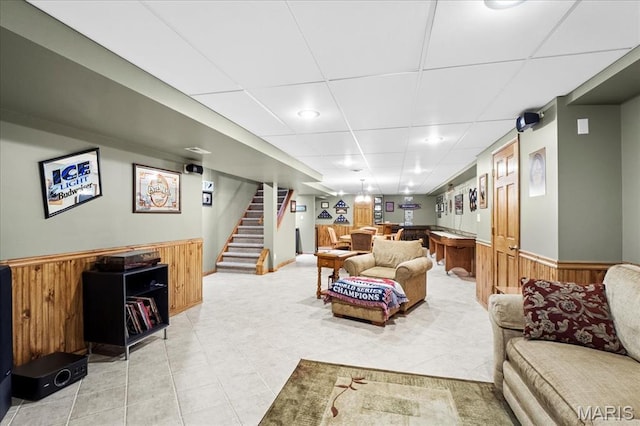13345 Iberg Rd, Highland, IL 62249 - living area featuring a wainscoted wall, a bar, stairs, wooden walls, and a paneled ceiling