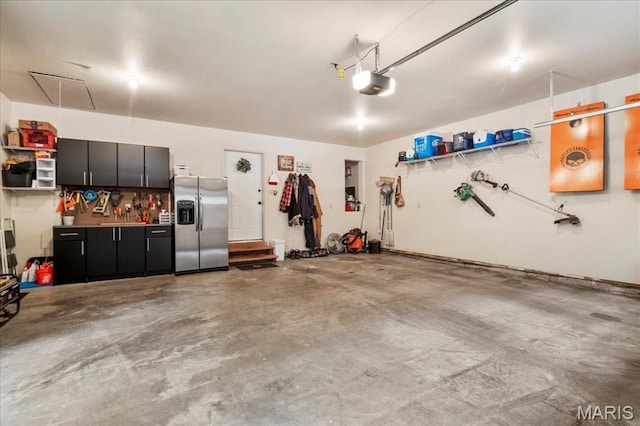 13345 Iberg Rd, Highland, IL 62249 - garage with stainless steel fridge and a garage door opener